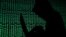 ILLUSTRATION -- FILE PHOTO: A hooded man holds a laptop computer as cyber code is projected on him in this illustration picture taken on May 13, 2017. 