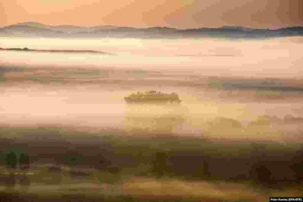 Morning mist covers the landscape near Stara Basta in southern Slovakia. (epa-EFE/Petr Komka)