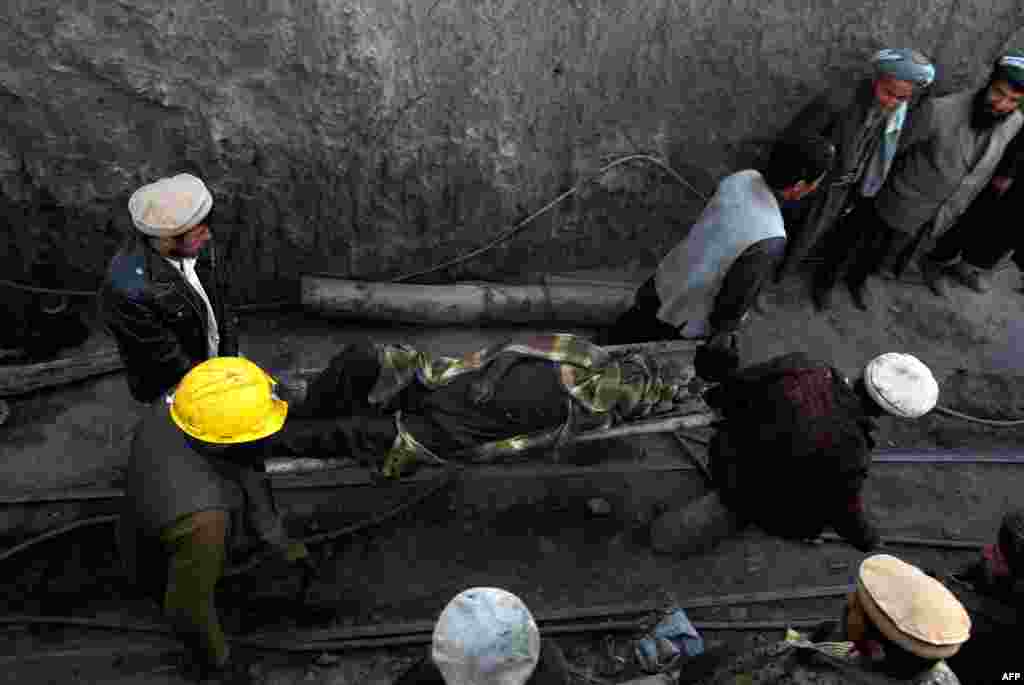 Miners carry the body of a dead colleague following the mine collapse.