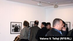 Visitors at the opening of the "Besa" photo exhibit in Pristina.