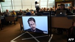 Edward Snowden speaks via video link from Russia as he takes part in a roundtable meeting on the subject of "Improving the protection of whistle-blowers" at the Council of Europe in Strasbourg, France, in March 2019.