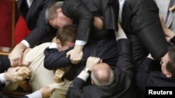 Deputies scuffle during a session of parliament in Kyiv in 2010, one of the many instances of political discourse that have lowered the bar for language in Ukraine.