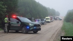 Military police and response vehicles stand parked near the site where, according to the Lithuanian National Crisis Management Center, am Italian NATO fighter jet shot down a drone in Lithuania, September 15, 2026.