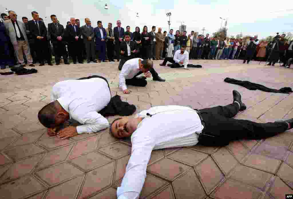 Iraqi Kurdish actors perform in a play in memory of the victims of a gas attack ordered by former Iraqi President Saddam Hussein in 1988 in the Kurdish town of Halabja. Some 5,000 civilians, mostly women and children, were killed in the chemical gas attack by Hussein's air force as part of a campaign to crush a Kurdish rebellion. (AFP/Safin Hamed)