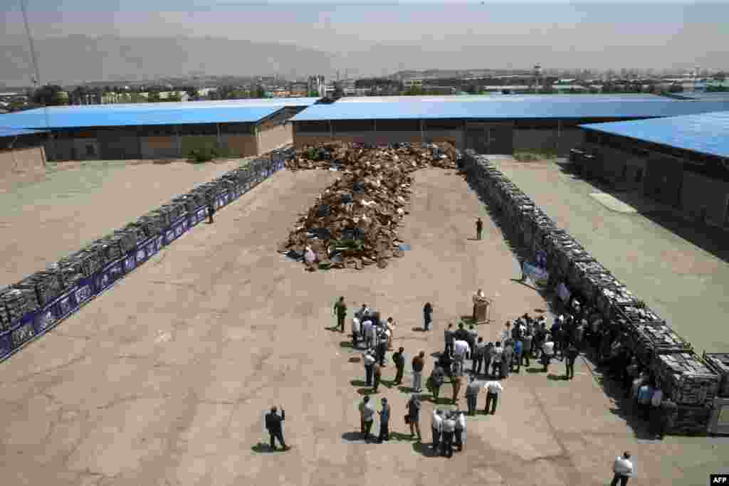 Iranian journalists and officials attend a ceremony during which satellite dishes and receivers are destroyed in the capital Tehran. (AFP/Tasnim News -- Hossein Zohrevand)