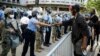 A protester fist-bumps Philadelphia police officer after police and Pennsylvania National Guard take a knee outside Philadelphia Police headquarters in Philadelphia, Monday, June 1, 2020.