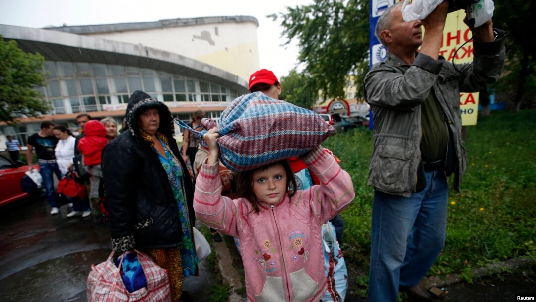 Residents of the Donetsk region in eastern Ukraine prepare to board buses for Rostov-on-Don in Russia from a collection point in the city of Donetsk on July 14.