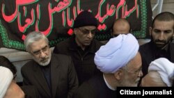 Opposition leaders Mir Hossein Musavi (left) and Mehdi Karrubi (with glasses and white turban) at a funeral procession for Grand Ayatollah Hossein Ali Montazeri in Qom in December.