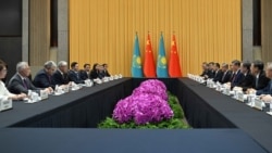 Chinese President Xi Jinping (center right) meets with Kazakhstan President Qasym-Zhomart Toqaev (center left) in Shanghai earlier this month. The two countries have seen their diplomatic and financial ties grow in recent years.