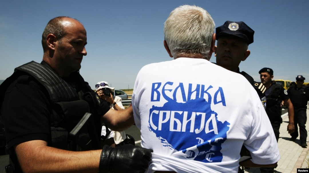 Police detain a Serb wearing a T-shirt reading "Greater Serbia" during a celebration of the anniversary of the 1389 Battle of Kosovo Polje at Gazimestan on June 28.
