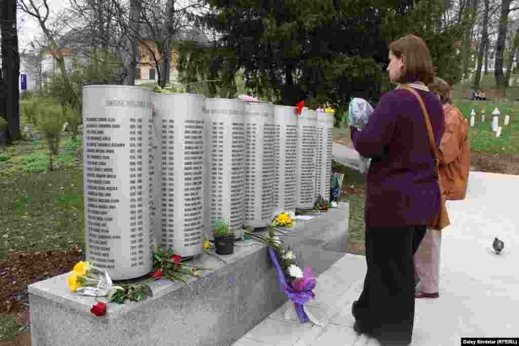 Sarajevans look at memorial scrolls bearing the names of some of the children killed.