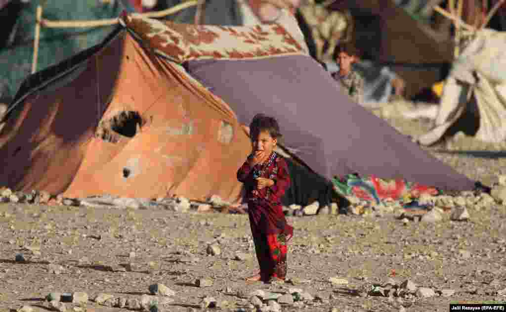 An internally displaced Afghan child is photographed near a temporary shelter in Herat. (epa-EFE/Jalil Rezayee)