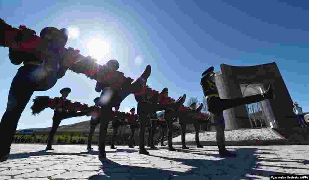 Kyrgyz national honor guards lay a wreath at a monument to those killed during the April 2010 uprising at the Ata-Beyit cemetery outside the capital, Bishkek, on April 7. (AFP/Vyacheslav Oseledko)