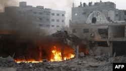 Smoke rises from a fire after Israeli air strikes in Gaza City on November 19.