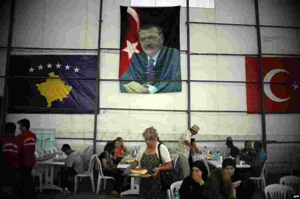 The Turkish flag and a picture of Turkish Prime Minister Recep Tayyip Erdogan hang on one side of the tent. Turkey is one of the main sponsors of the free dinner program.