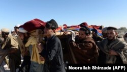 Afghan mourners carry the coffin of one of the victims of a U.S. air strike in the Achin district of Nangarhar province on January 12