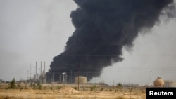 Smoke rises from the oil refinery in Baiji on October 14.
