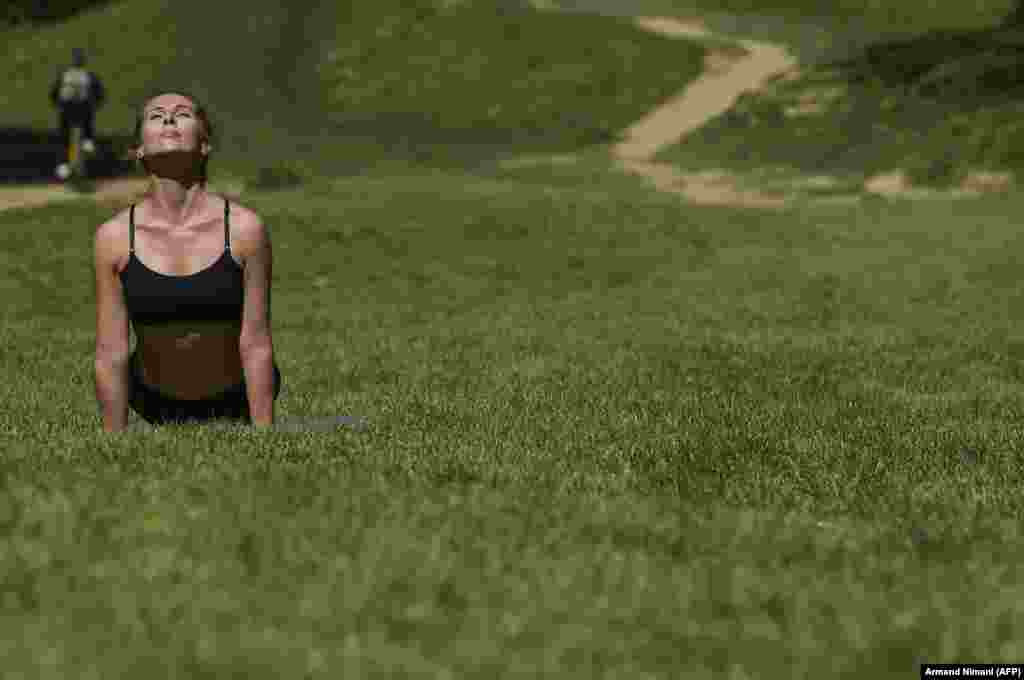 A woman practices yoga during activities marking Earth Day in Germia National Park, near Pristina in Kosovo on April 22. (AFP/Armend Nimani)