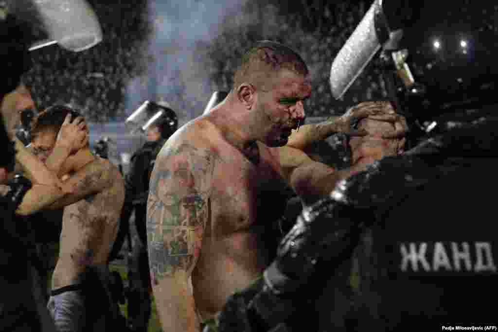 Police arrest Partizan Belgrade hooligans after clashes between two groups of Partizan Belgrade supporters during the Serbian Superleague derby football match between Partizan Belgrade and Crvena Zvezda (Red Star) in Belgrade. (AFP/Pedja Milosavljevic)