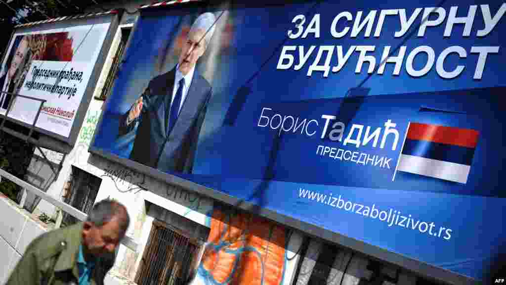 A man walks past election billboards in Belgrade that show presidential candidates Boris Tadic (right) and Tomislav Nikolic. Tadic won 26.7 percent and Nikolic 25.5 in the first round. (AFP PHOTO/ANDREJ ISAKOVIC)