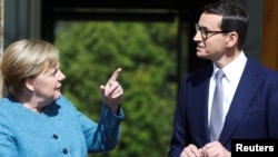 German Chancellor Angela Merkel (left) speaks with Polish Prime Minister Mateusz Morawiecki at the Palace on the Isle in Royal Lazienki Park in Warsaw on September 11.