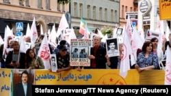 Supporters of the Mujahedin-e Khalq Organization protest outside Stockholm District Court of Hamid Nouri's trial in August 2021.