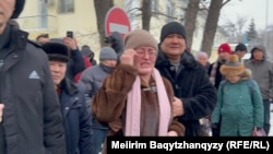 Oralkhan Aben (center) cries in front of a courtroom in January as her husband, Tursynbek Qabiuly, and 18 other activists go on trial.