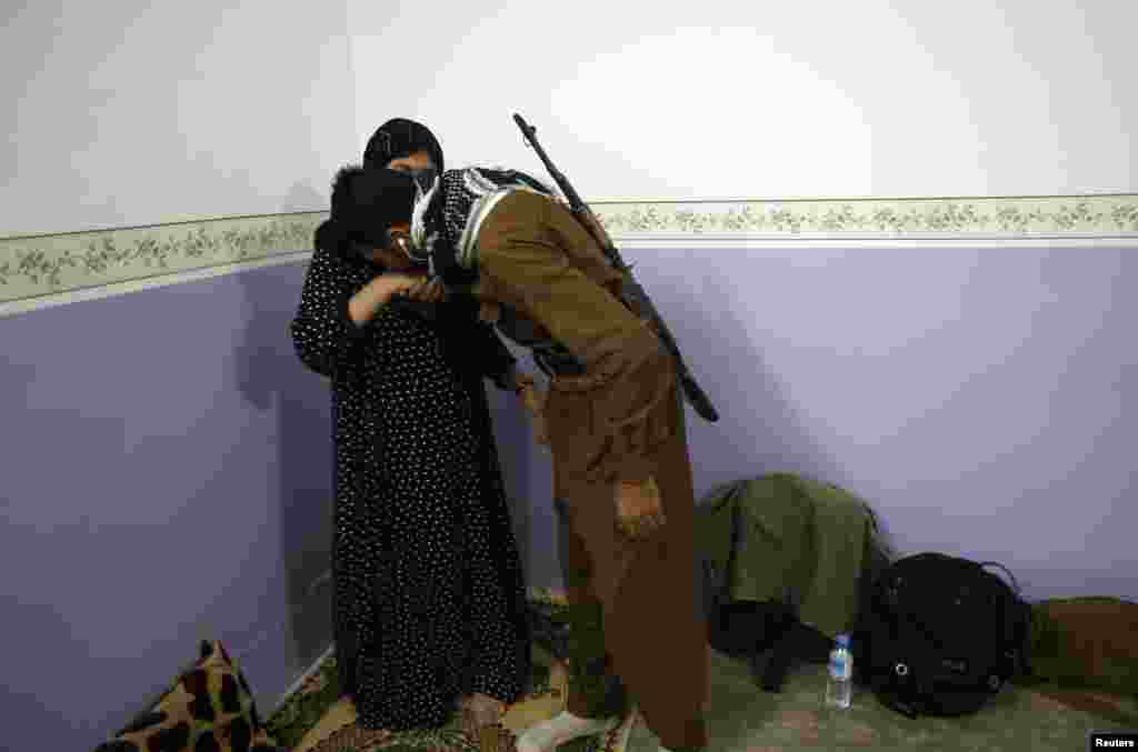 A mother says goodbye to her son, a volunteer in the Kurdish peshmerga forces fighting IS militants, as he prepares to leave home for the front line near Tuz Khurmatu, northeast of Tikrit city, Iraq, on August 31. (Reuters/Youssef Boudlal)