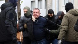 Ukrainian Security Service officers detain Major General Valeriy Shaytanov on suspicion of high treason and terrorism in Kyiv on April 14.