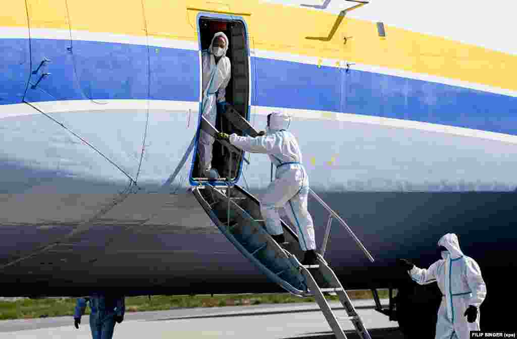 The crew of the Antonov wearing protective equipment after landing in Leipzig on April 27