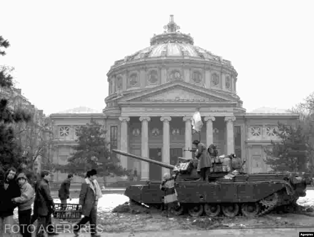 București, 26 decembrie 1989. În ciuda tancurilor aflate încă pe străzi, atmosfera începe să se liniștească. Nicolae și Elena Ceaușescu fuseseră executați la o garnizoană din Târgoviște în urma unui simulacru de proces. Consiliul Frontului Salvării Naționale preluase puterea, ca organism neutru, cu rolul principal de a administra țara și de a organiza alegeri libere. La finele lunii ianuarie, președintele CFSN și premierul Roman anunță transformarea FSN în partid politic, ceea ce a debalansat complet spectrul politic, readucându-l în matricea perestroikai. Manifestațiile maraton vor menține însă România în linia democrațiilor de tip occidental definite de pluralism.&nbsp;&nbsp;