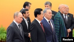 Security issues are likely to be high on the agenda as Afghan President Hamid Karzai (second from right) attends this month's SCO summit as an observer. (file photo from the 2012 SCO summit)