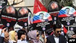 People protest against Russia for its alleged role in a chemical attack in the Syrian province of Idlib, in front of the Russian Embassy, in Ankara, on April 7.