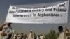 Men hold a banner aloft during a demonstration in Kabul against crossborder shelling attacks on August 30.