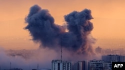 A plume of smoke rises after a strike on the Iranian capital Tehran, on March 3, 2026.