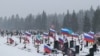 Flags fly over the graves of Russian soldiers at a cemetery in Saint Petersburg