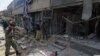 Afghan security personnel inspect the site of a suicide attack outside a bank near the U.S. Embassy in Kabul on August 29.