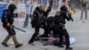 Law enforcement officers detain a protester following multiple detentions by ICE in downtown Los Angeles, California, on June 6. 
