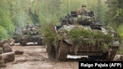 Soldiers on tanks take part in a large-scale exercise with the participation of NATO troops near the Estonian border with Russia in 2021.