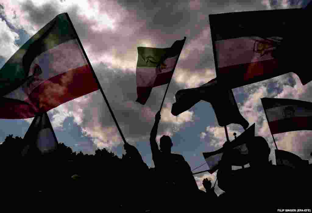 People attend a protest against the Iranian government in Berlin, Germany.