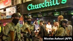 Riot police march in Wan Chai district, a touristic area where foreigners gather in bars, in Hong Kong on October 4, 2019