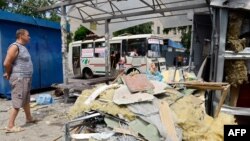 A man looks at a bus stop destroyed as a result of combat between Ukrainian forces and pro-Russian militants on the outskirts of Donetsk on July 25.