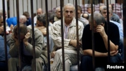 Українці, звинувачені в співпраці з режимом Каддафі, в залі суду в Тріполі, 10 квітня 2013 року