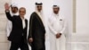 Iranian President Masud Pezeshkian (left) and Qatari Emir Sheikh Tamim bin Hamad al-Thani arrive at a joint press conference in Doha on October 2.