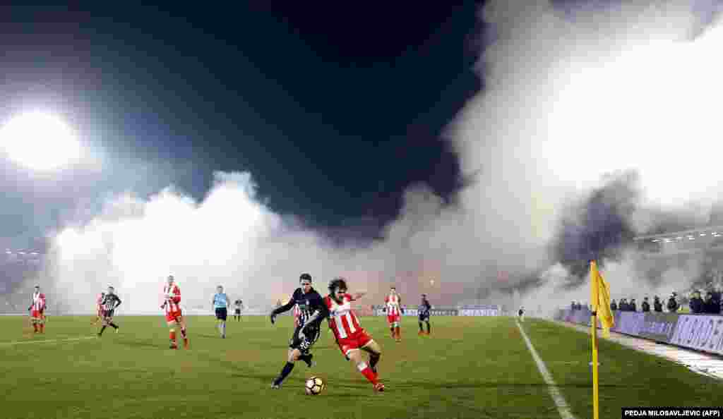Smoke from the stands obscures part of the pitch during a Red Star versus Partizan match in December 2017.