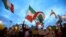 People wave flags during a demonstration in support of the protests in Iran, in Barcelona, Spain on January 13