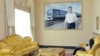 A woman relaxes underneath a photo of President Gurbanguly Berdymukhammedov at the resort of Avaza.