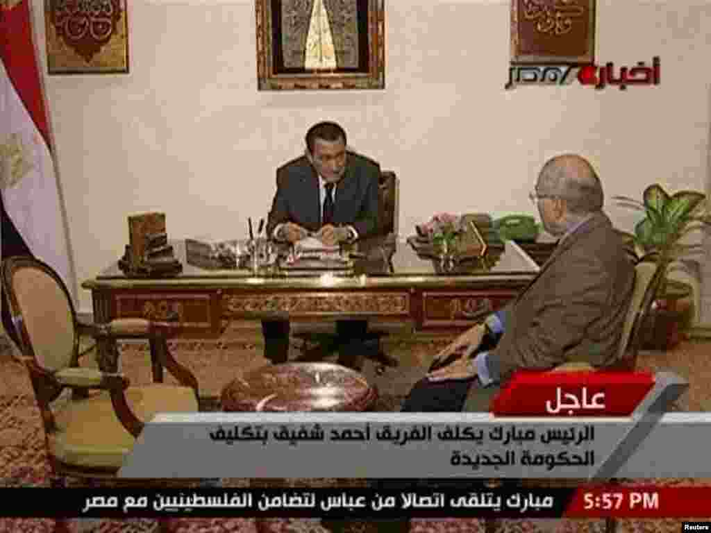 President Hosni Mubarak speaks with his newly named Prime Minister Ahmed Shafiq in Cairo on January 29.