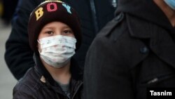 Young boy waiting to be examined by a mobile medical team in Qom, the epicenter of coronavirus outbreak in Iran. February 27, 2020. 