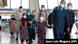 Families evacuated from Kabul arrive at Washington Dulles International Airport in 2021.